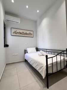 sypialnia z łóżkiem i zdjęciem na ścianie w obiekcie Chic Getaway Near Stavros Niarchos w Atenach