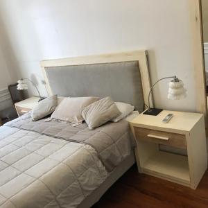 um quarto com uma cama com uma mesa-de-cabeceira e uma cama sidx sidx em Beautiful Classic Style Apartment in Buenos Aires Downtown em Buenos Aires