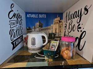 a counter with a coffee maker and a sign on a wall at AdriVA Apartamento-Loft Imperial centro WIFI in Valladolid