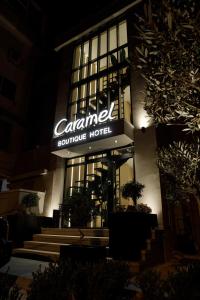 a building with a sign on the front of it at Caramel Boutique Hotel in Gjirokastër