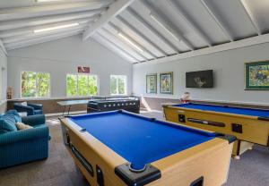 a living room with a pool table in it at Mount Castleton in Plettenberg Bay