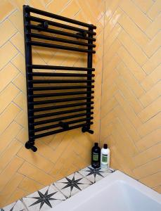 a bath tub with two bottles of wine on a wall at Durham City Retreat in Durham