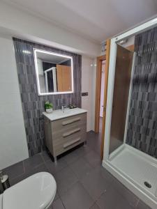 a bathroom with a toilet and a sink and a shower at Tranquilidad a la Orilla del Mar in Villajoyosa +20 photos