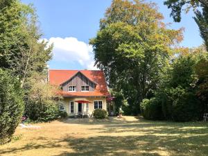 a house in the middle of a yard with trees at Haus am See in Wasserburg am Bodensee