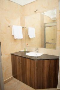 a bathroom with a sink and a mirror at TURACO INTERCOUNTY RESORT in Maragoli