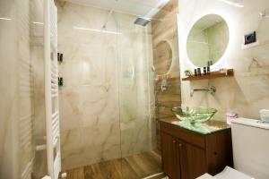 een badkamer met een glazen douche en een wastafel bij Thessaloniki Amazing Apartment in Thessaloniki