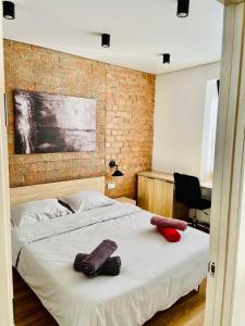 a bedroom with a bed with two towels on it at Brick Apart Melnyka10 in Ivano-Frankivsʼk