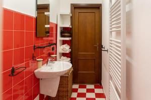 a small bathroom with a sink and a door at Magico Loft nel Centro Storico in Toscolano Maderno