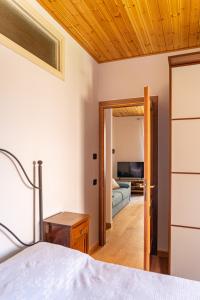 a bedroom with a bed and a living room at Magico Loft nel Centro Storico in Toscolano Maderno