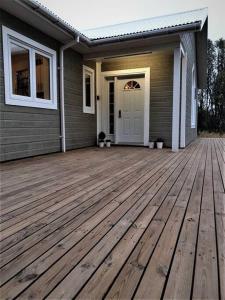 a wooden deck in front of a house at Greenhouse Golden Circle Villa in Reykholt