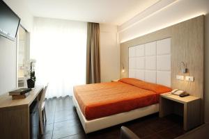 a hotel room with a bed and a television at Hotel Fantasy in Riccione