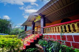 a colorful house with stairs in front of it at Royal Nest Villa in Mahabaleshwar