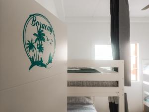 a bedroom with a sign on the wall at Daydream Medano Coliving in El Médano