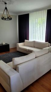 a living room with two white couches in front of a window at 3+1 Bağdat Caddesine yakın in Istanbul
