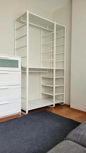a closet with white shelves and a rug at 3+1 Bağdat Caddesine yakın in Istanbul
