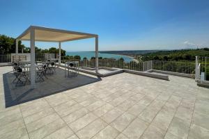 a patio with a gazebo and tables and chairs at Villa Caravaggio Comfort e Relax in Rocca San Giovanni