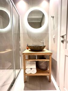 a bathroom with a sink and a shower at Sofos Suites Mykonos in Mikonos +42 photos