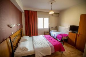 Postel nebo postele na pokoji v ubytování Giannis Hotel