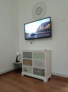 a flat screen tv on a wall above a dresser at Kuća za odmor BIĐ 