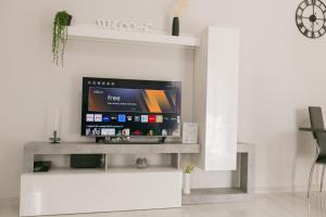 a living room with a flat screen tv on a wall at [Crotone 5 Stelle] Free Parking, Netflix, Wi-Fi in Crotone