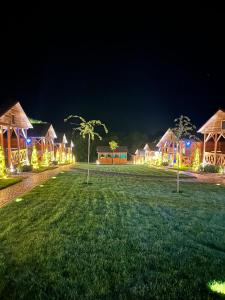 a row of cottages lit up at night at СИНІ ВОДИ база відпочинку 