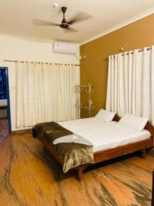 a bed in a room with a ceiling at hello beach view resorts in Varkala