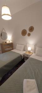 a bedroom with two beds and two lights and two tables at Orizodas in Lipsoi