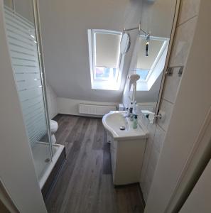 a small bathroom with a sink and a mirror at W3 Ferienwohnung-32609 Hüllhorst Minden-Lübbecke in Hüllhorst