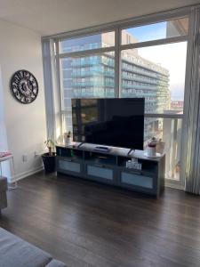 a living room with a large flat screen tv at Condo Room for rent in Toronto