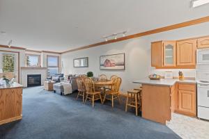 a kitchen and living room with a table and chairs at Silver Peaks in Silver Star