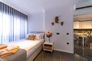 a bedroom with a bed with a vase of flowers on a table at Deluxe Marine House in Marmaris