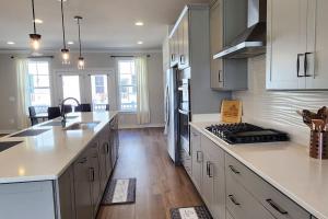 a kitchen with white cabinets and a counter top at Luxury in Fredericksburg in Fredericksburg +21 photos