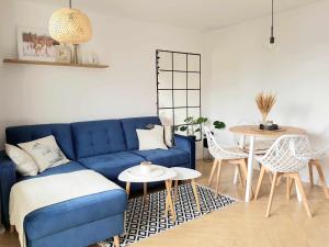 a living room with a blue couch and a table at MoreLove I in Sandomierz