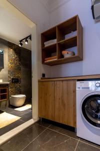 a washer and dryer in a bathroom with a toilet at Deluxe Marine House in Marmaris