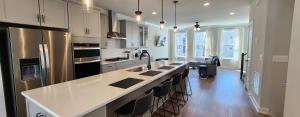a kitchen with a large white counter top and stainless steel appliances at Luxury in Fredericksburg in Fredericksburg