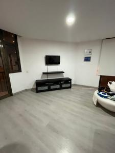 a living room with a flat screen tv on the wall at Vista Mar Playa de las Canteras in Las Palmas de Gran Canaria