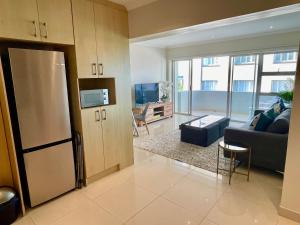 a large living room with a couch and a table at Ideal location, Mouille Point in Cape Town