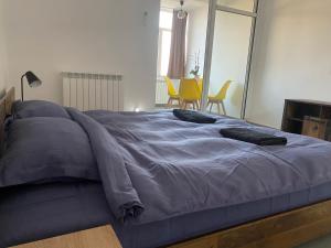 uma cama grande num quarto com cadeiras amarelas em Casa Cojocaru em Turnu Măgurele