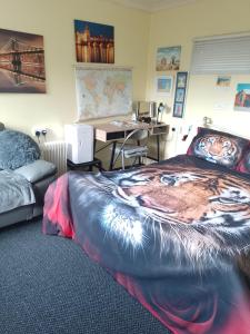 a bedroom with a bed with a tiger painted on it at STUDIO PAD in Cardiff