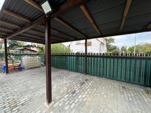 a covered patio with a green fence at Tomy Apartment O2 arena PVA expo in Prague