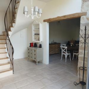 a kitchen and dining room with a staircase and a table at Grande suite en duplex avec 2 chambres, terrasse dans corps de ferme in Villiers-sous-Grez