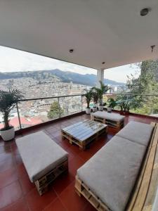 a balcony with benches and a view of a city at The Temple, Quito in Quito