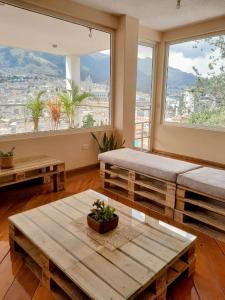 a room with two tables and a large window at The Temple, Quito in Quito