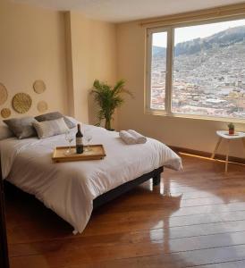 a bedroom with a large bed with a table on it at The Temple, Quito in Quito