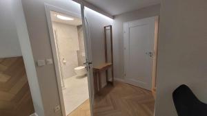 a bathroom with a toilet and a glass door at Hotel & Restauracja Wróblewscy in Karniewo +27 photos