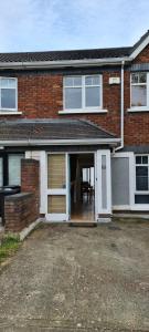 a brick house with a garage with a table in it at Private shared room near Blanchardstown shopping center 