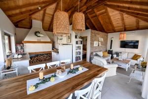a kitchen and living room with a large wooden table at Top - kuća za odmor in Bukovik