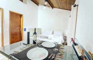 a dining table with two plates on top of it at Chalé Mantiqueira in Cunha