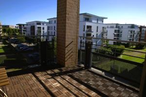 a balcony with a black fence and some buildings at Lovely Modern 1 BR apartment in Luxembourg