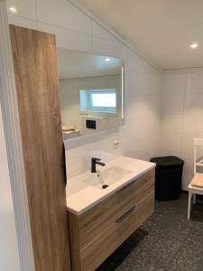 a bathroom with a sink and a mirror at Sivert´s kontorhotell in Tomrefjord